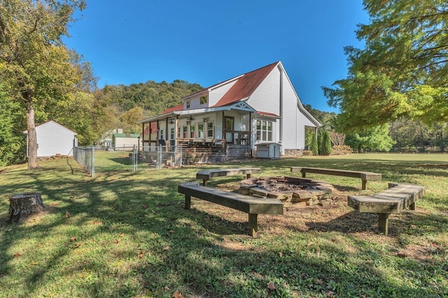 view of yard with an outdoor fire pit, a gate, and fence