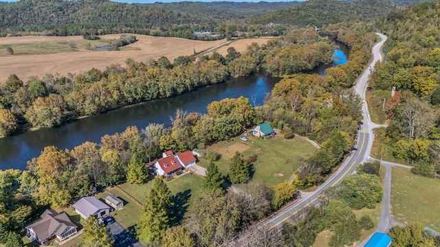 aerial view with a water view and a wooded view