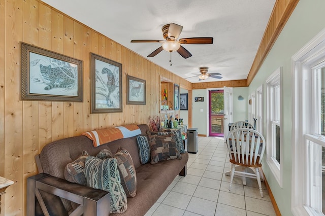 living area featuring wood walls and light tile patterned floors