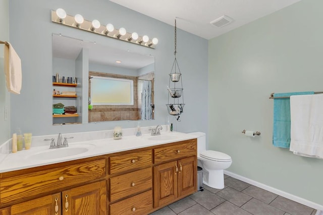 full bath featuring double vanity, tile patterned flooring, visible vents, and a sink