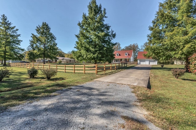 exterior space with a rural view, fence, and a lawn