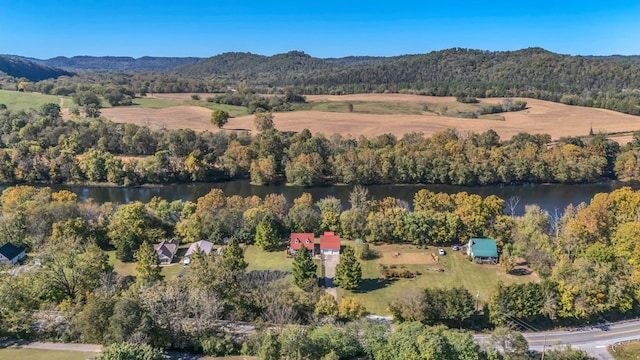 birds eye view of property with a wooded view and a water and mountain view