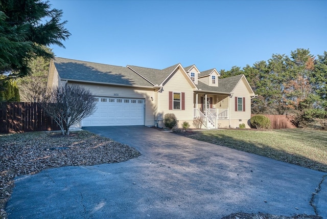 view of front of home featuring an attached garage, covered porch, fence, driveway, and a front lawn