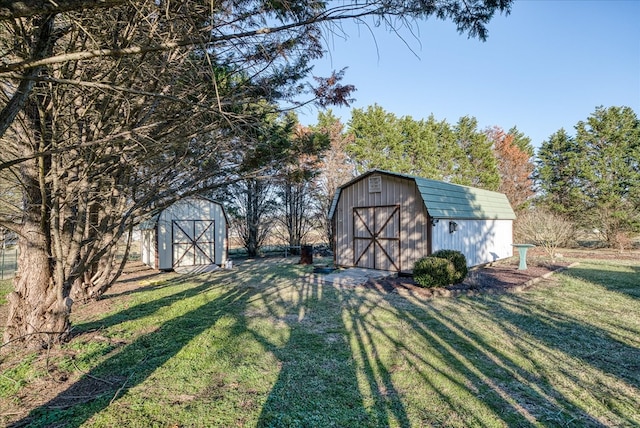 view of yard with a storage shed and an outbuilding