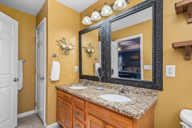 ensuite bathroom with tile patterned floors, a sink, ensuite bath, and double vanity