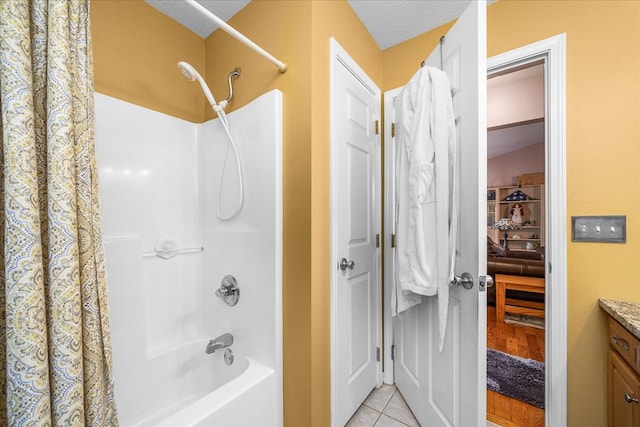 full bath featuring shower / bath combination with curtain, tile patterned flooring, a textured ceiling, and vanity