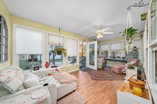 sunroom / solarium with a ceiling fan