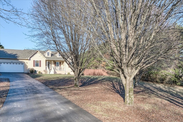 view of front of home with driveway, a garage, and fence