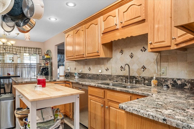 kitchen with tasteful backsplash, dishwasher, butcher block counters, a sink, and recessed lighting