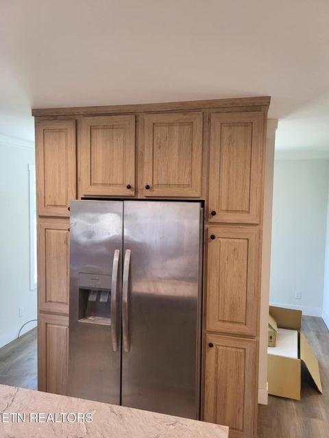 216 Valerie Dr, Deer Lodge, TN 37726 - kitchen featuring stainless steel refrigerator with ice dispenser, wood finished floors, light stone countertops, and crown molding