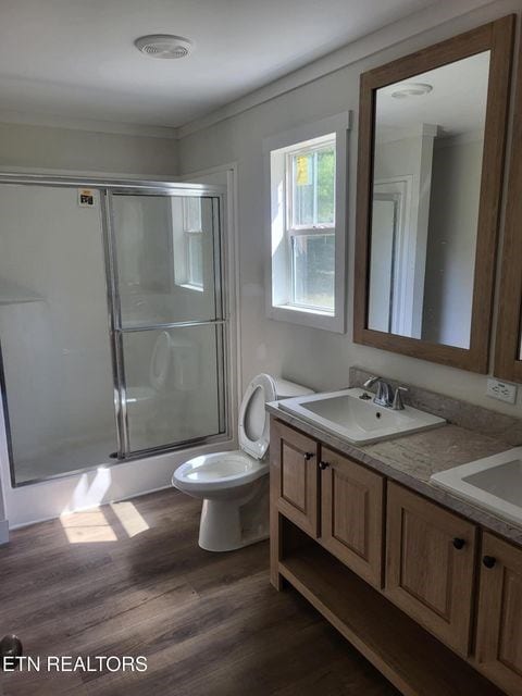216 Valerie Dr, Deer Lodge, TN 37726 - full bathroom featuring double vanity, a stall shower, wood finished floors, and crown molding