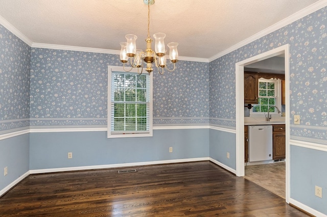 unfurnished dining area with dark wood-type flooring, visible vents, wallpapered walls, an inviting chandelier, and crown molding