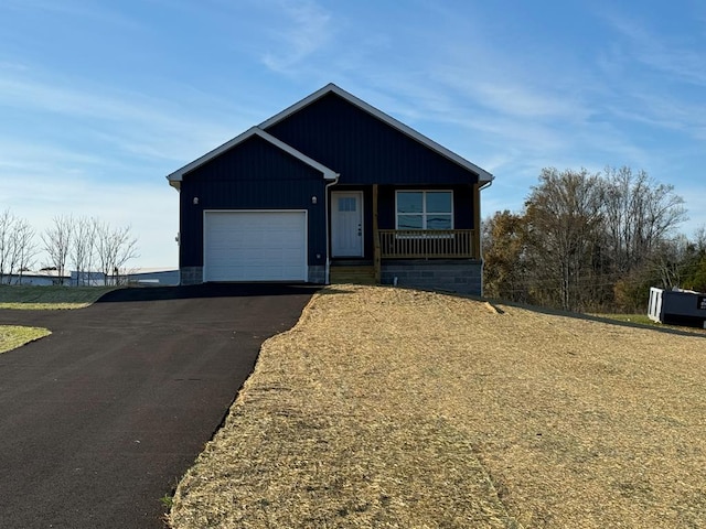 view of front of home featuring aphalt driveway, a garage, and board and batten siding