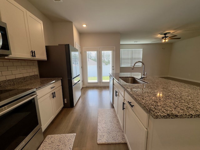 336 Oliver Way, Baxter, TN 38544 - kitchen featuring a sink, appliances with stainless steel finishes, white cabinets, dark stone countertops, and recessed lighting