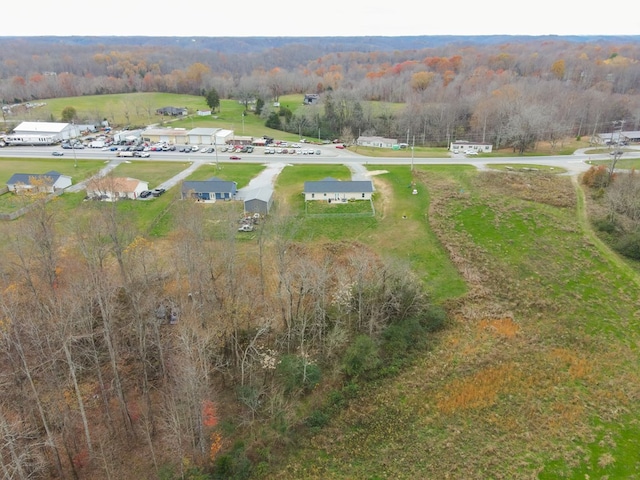 drone / aerial view featuring a forest view