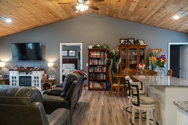 living room featuring lofted ceiling, visible vents, a ceiling fan, wood ceiling, and light wood-type flooring