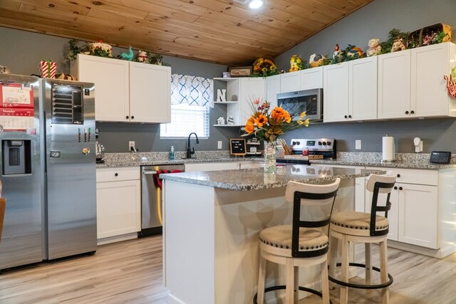 kitchen featuring light stone countertops, white cabinetry, and stainless steel appliances