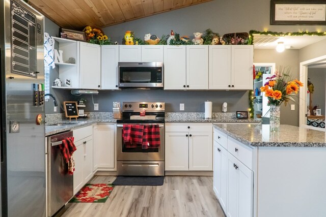 kitchen featuring appliances with stainless steel finishes, white cabinets, a sink, and open shelves