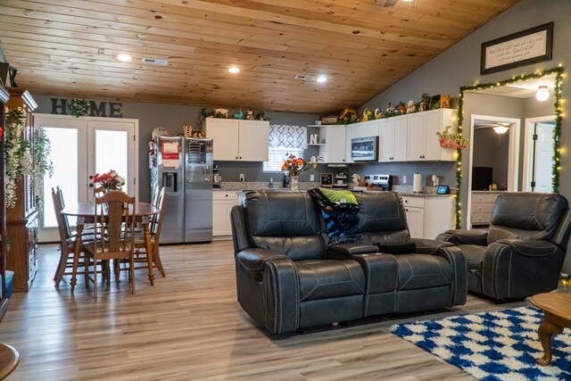 living room featuring lofted ceiling, french doors, light wood finished floors, and wood ceiling