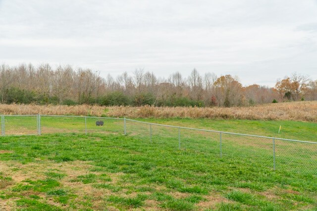 view of yard with a rural view and fence