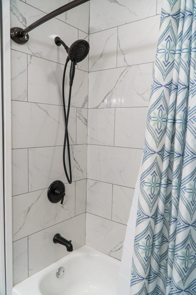 bathroom with shower / tub combo with curtain