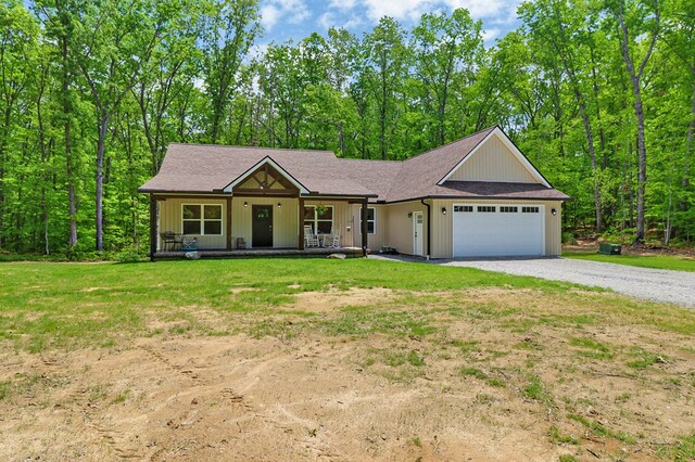 98 Paso Fino Trl, Jamestown, TN 38556 - view of front facade with an attached garage, driveway, a porch, and a front lawn