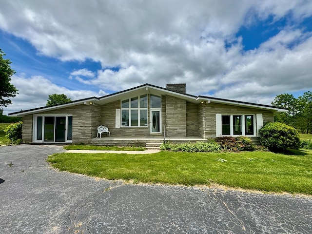1039 Old Martha Washington Rd, Clarkrange, TN 38553 - view of front of house featuring stone siding, a chimney, and a front lawn
