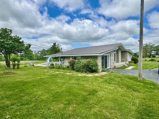 1039 Old Martha Washington Rd, Clarkrange, TN 38553 - view of side of home with stone siding, a lawn, and a metal roof