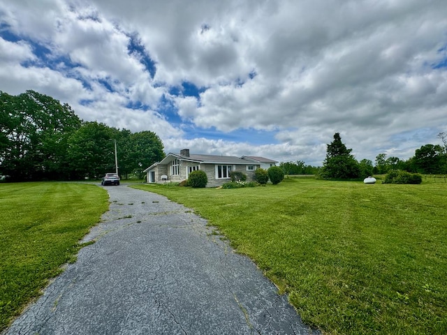 1039 Old Martha Washington Rd, Clarkrange, TN 38553 - view of front of home featuring a front lawn, a chimney, and asphalt driveway