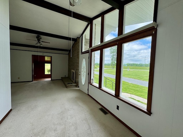 1039 Old Martha Washington Rd, Clarkrange, TN 38553 - unfurnished living room featuring beamed ceiling, a ceiling fan, a brick fireplace, carpet floors, and high vaulted ceiling