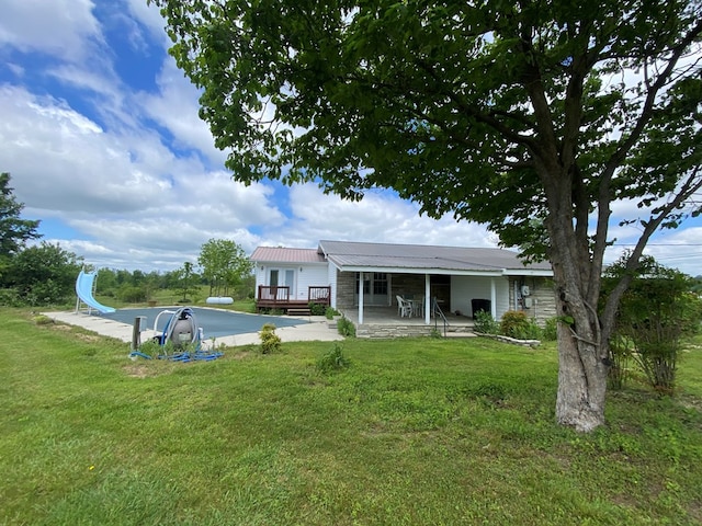 1039 Old Martha Washington Rd, Clarkrange, TN 38553 - rear view of house with a yard, a metal roof, and a wooden deck