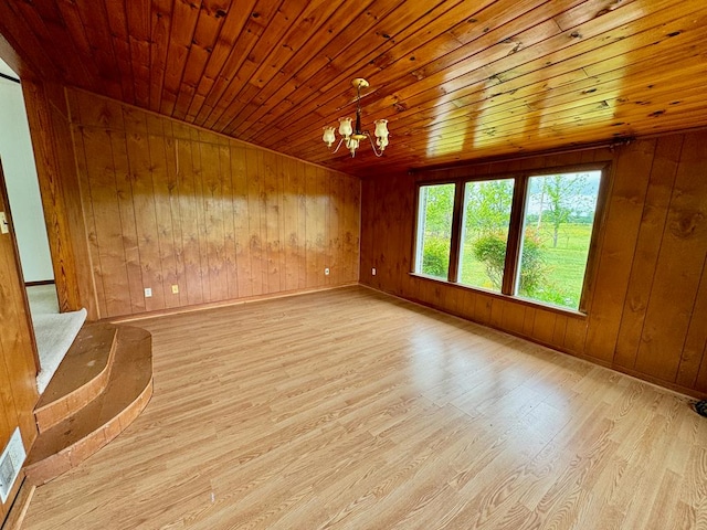 1039 Old Martha Washington Rd, Clarkrange, TN 38553 - empty room featuring wood ceiling, wood walls, a chandelier, wood finished floors, and stairway