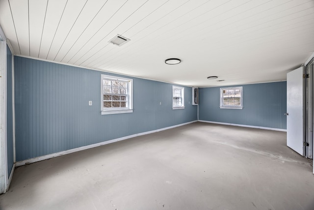 empty room with visible vents, concrete flooring, and baseboards