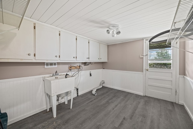 laundry area with a wainscoted wall, cabinet space, wood ceiling, and dark wood-style floors