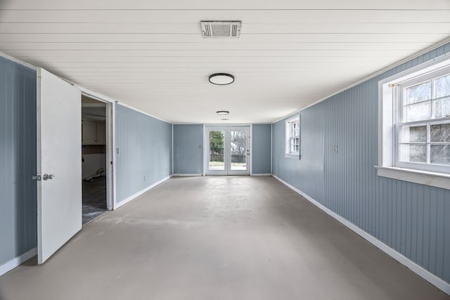 unfurnished room featuring visible vents, baseboards, and finished concrete flooring