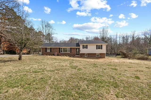 view of front of property with brick siding and a front lawn