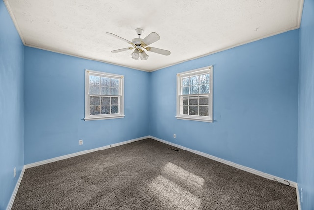 empty room featuring carpet flooring, baseboards, a textured ceiling, and a ceiling fan