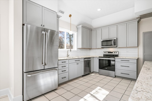 kitchen with gray cabinetry, visible vents, appliances with stainless steel finishes, tasteful backsplash, and decorative light fixtures