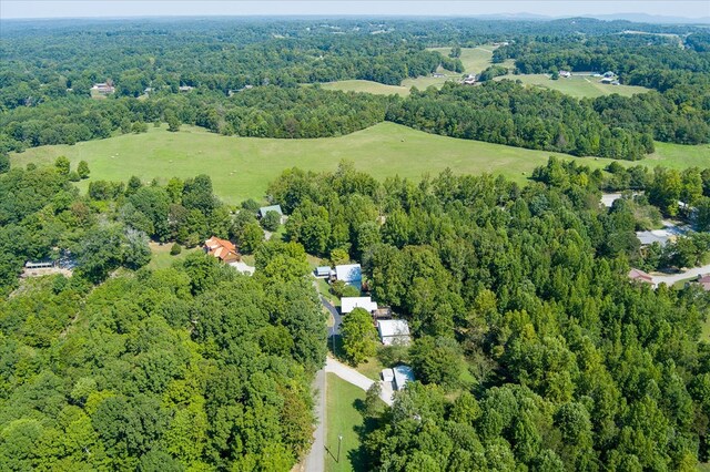 drone / aerial view with a wooded view