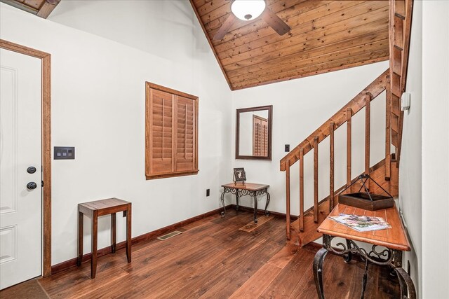 foyer entrance featuring dark wood-style floors, visible vents, stairs, vaulted ceiling, and wood ceiling