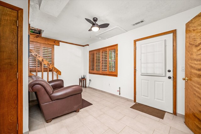 sitting room featuring a ceiling fan, a healthy amount of sunlight, and visible vents