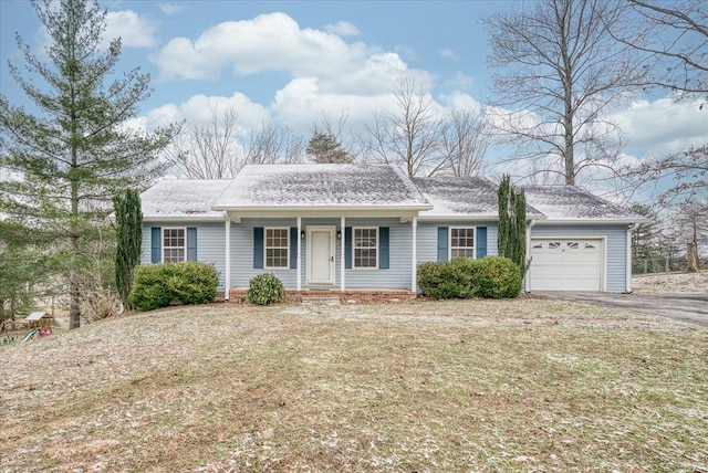 ranch-style home featuring a garage, aphalt driveway, a front lawn, and a porch