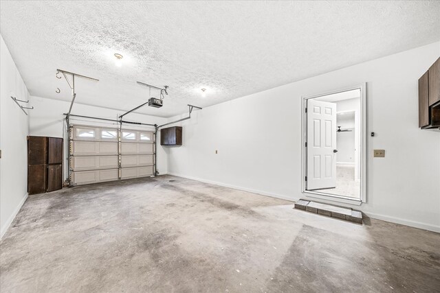 garage featuring baseboards and a garage door opener