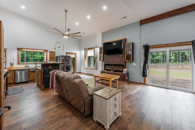 294 Big Piney Loop, Wilder, TN 38589 - living area with high vaulted ceiling, a glass covered fireplace, ceiling fan, dark wood-style flooring, and recessed lighting