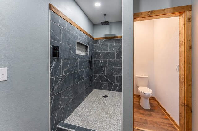 294 Big Piney Loop, Wilder, TN 38589 - full bath featuring toilet, wood finished floors, and a tile shower