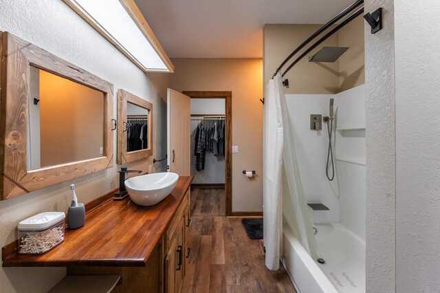 294 Big Piney Loop, Wilder, TN 38589 - bathroom featuring hardwood / wood-style floors, vanity, shower / tub combo, a walk in closet, and a textured wall