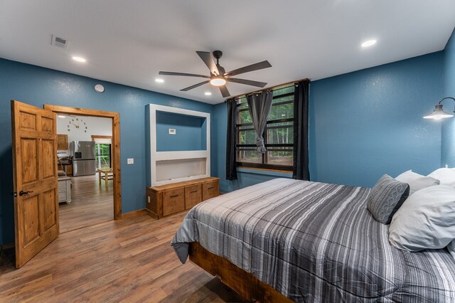 294 Big Piney Loop, Wilder, TN 38589 - bedroom with stainless steel refrigerator with ice dispenser, wood finished floors, multiple windows, recessed lighting, and baseboards