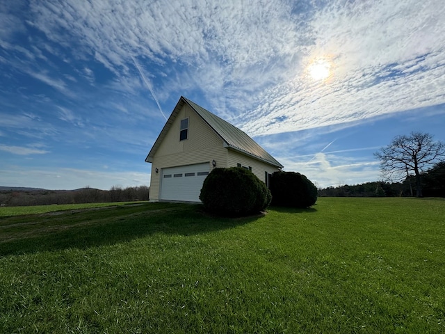 1032 Kendall Smith Rd, Pikeville, TN 37367 - view of side of property featuring a lawn, an outbuilding, driveway, and a garage