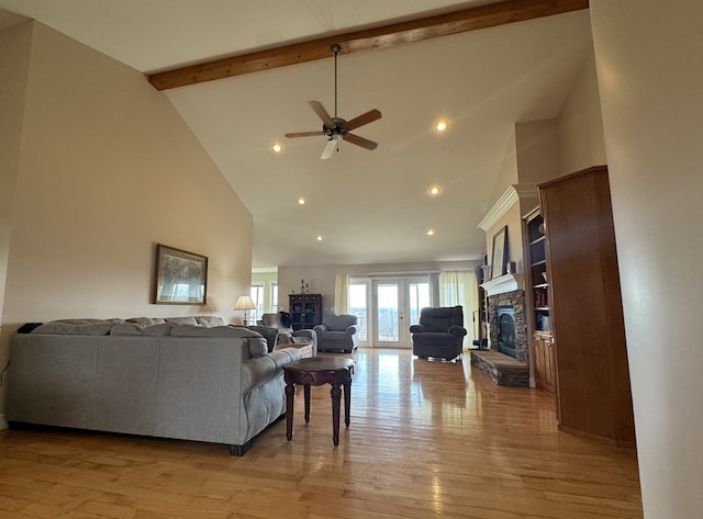 1032 Kendall Smith Rd, Pikeville, TN 37367 - living room with high vaulted ceiling, a stone fireplace, a ceiling fan, beam ceiling, and light wood-style flooring