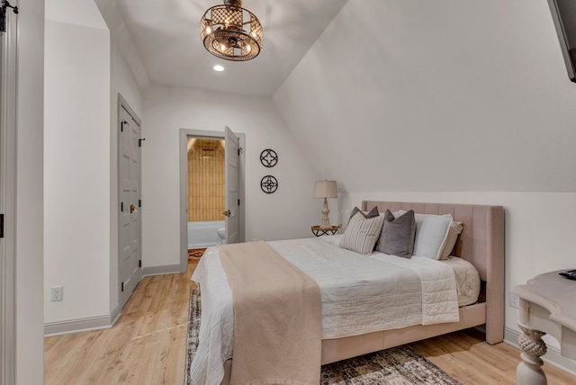 bedroom featuring lofted ceiling, light wood-style flooring, baseboards, and a notable chandelier